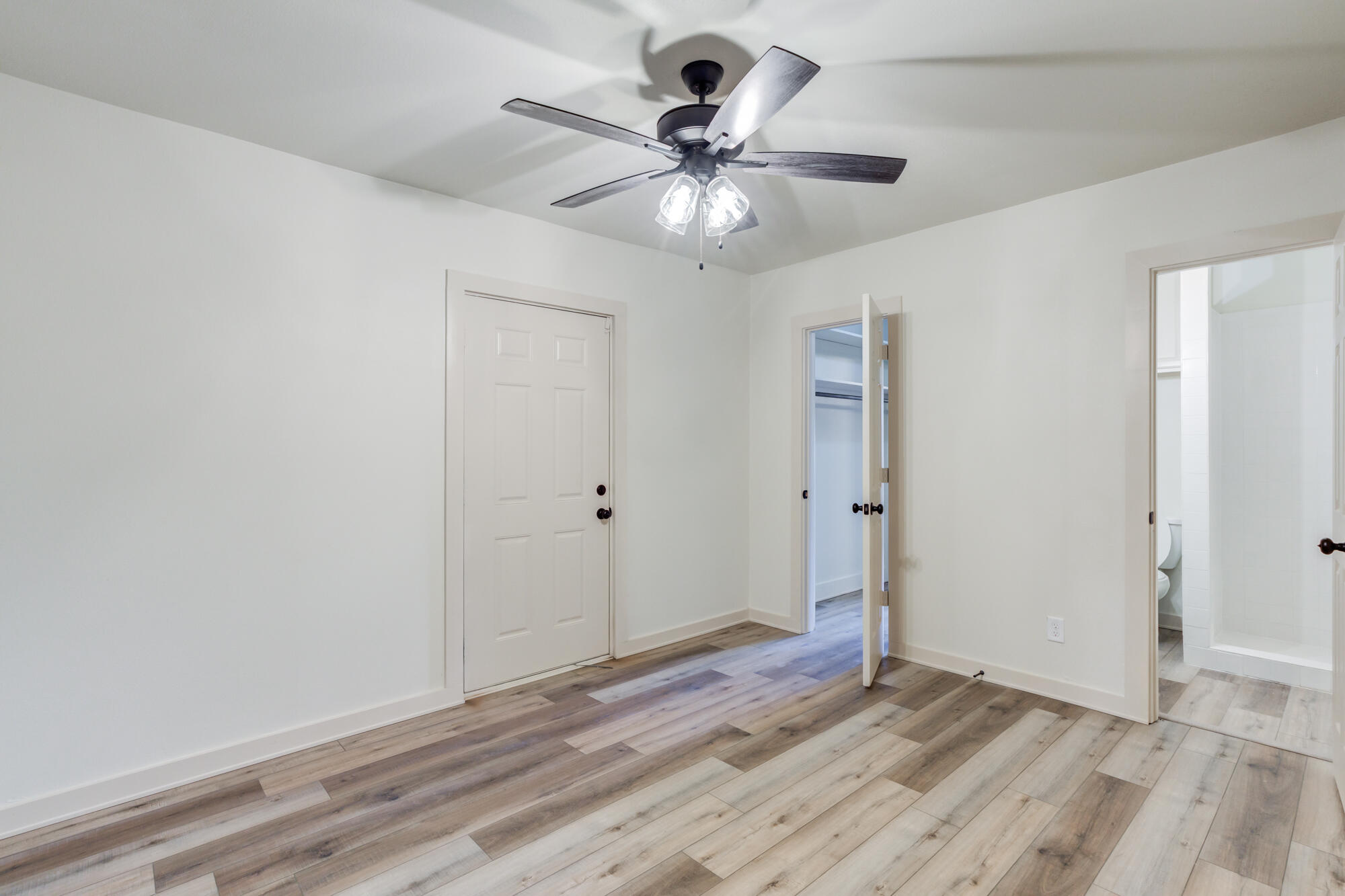 315 West Garza Street Slaton, TX 79364 - Photo 22 of 35 a view of an empty room with wooden floor