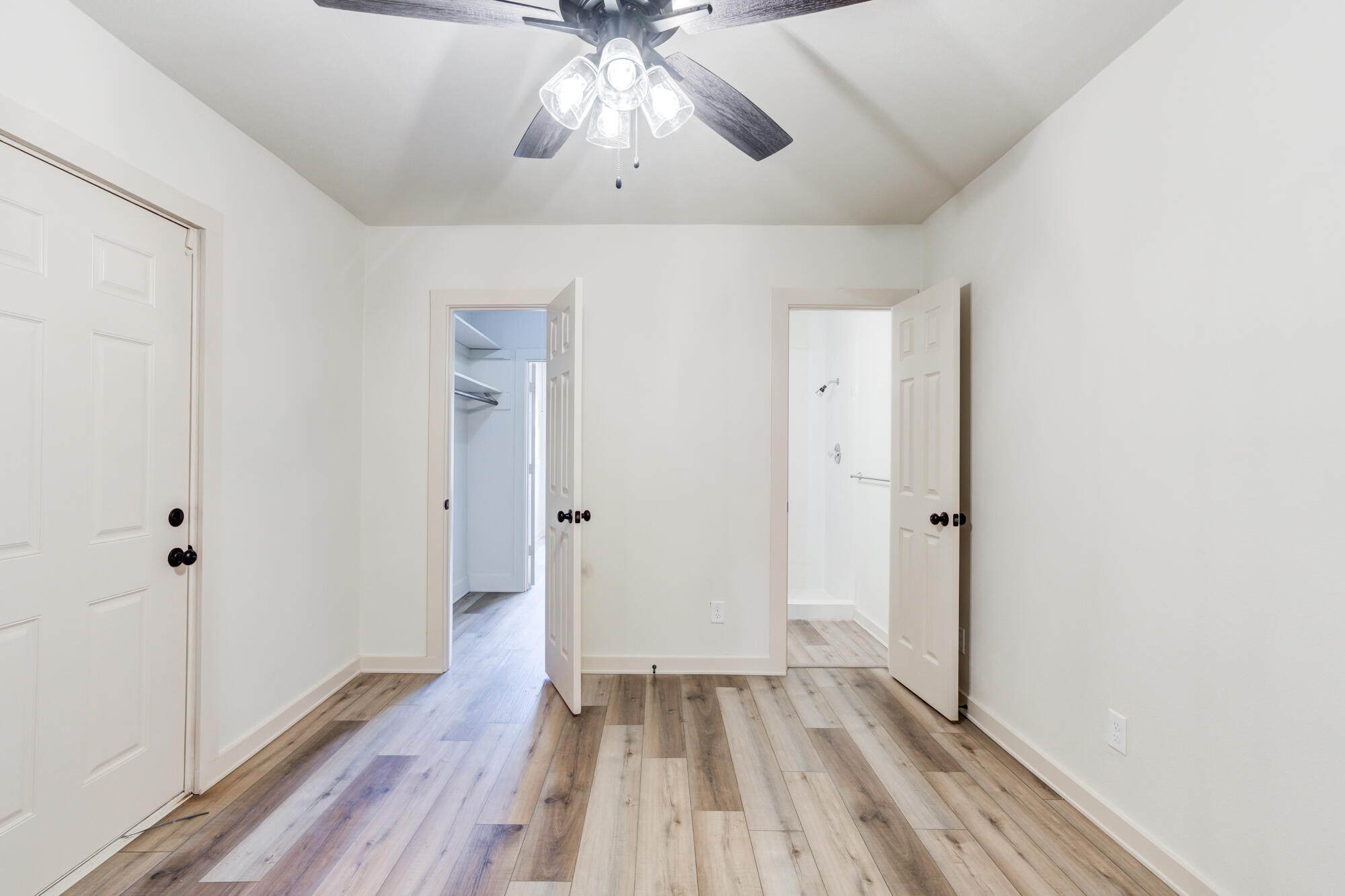 315 West Garza Street Slaton, TX 79364 - Photo 23 of 35 wooden floor in an empty room with a window