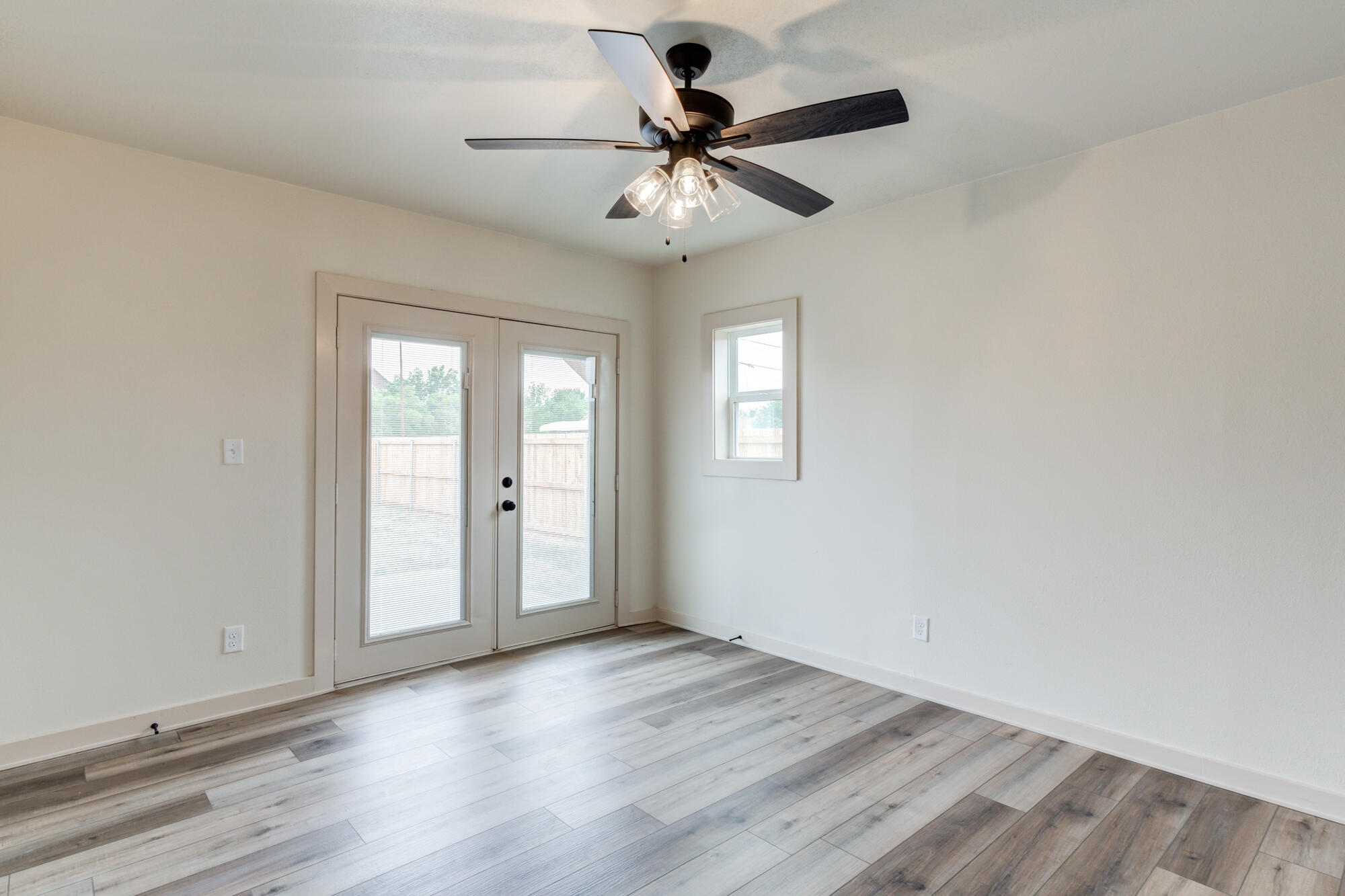 315 West Garza Street Slaton, TX 79364 - Photo 29 of 35 wooden floor in an empty room with a window