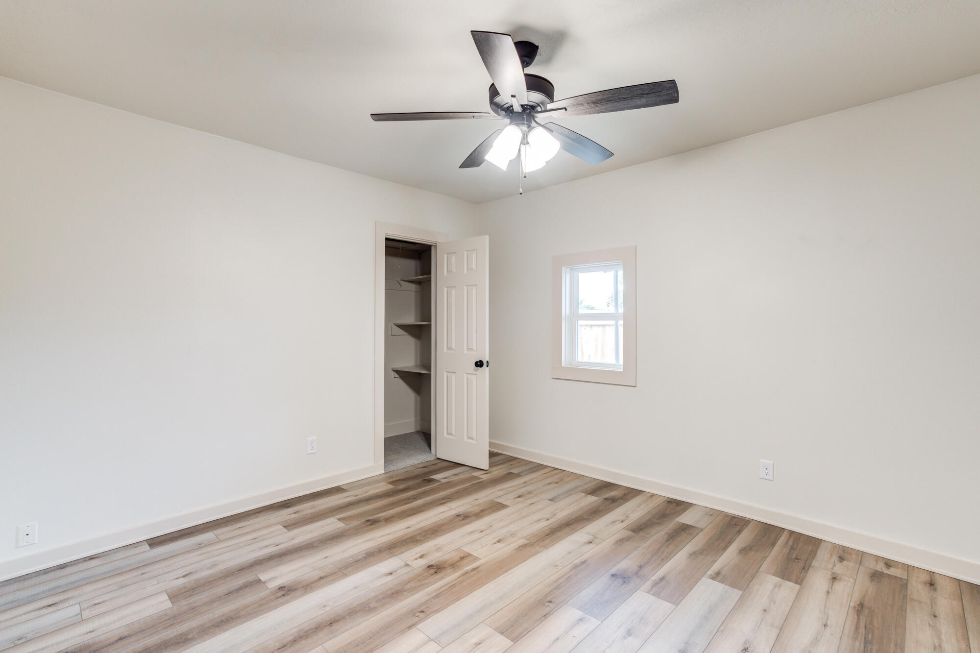 315 West Garza Street Slaton, TX 79364 - Photo 31 of 35 a view of a livingroom with a ceiling fan and window