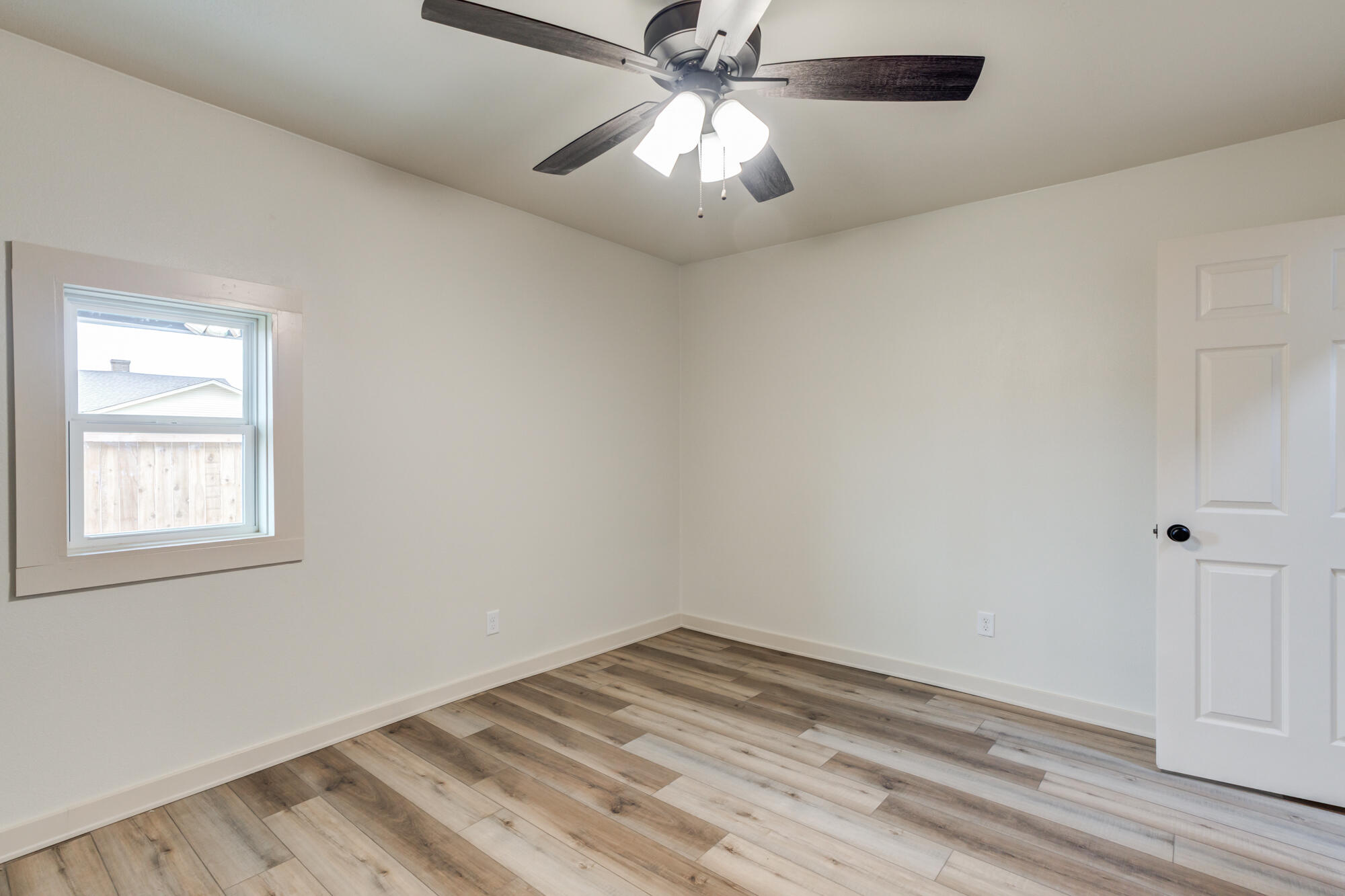 315 West Garza Street Slaton, TX 79364 - Photo 32 of 35 an empty room with a window and a chandelier fan