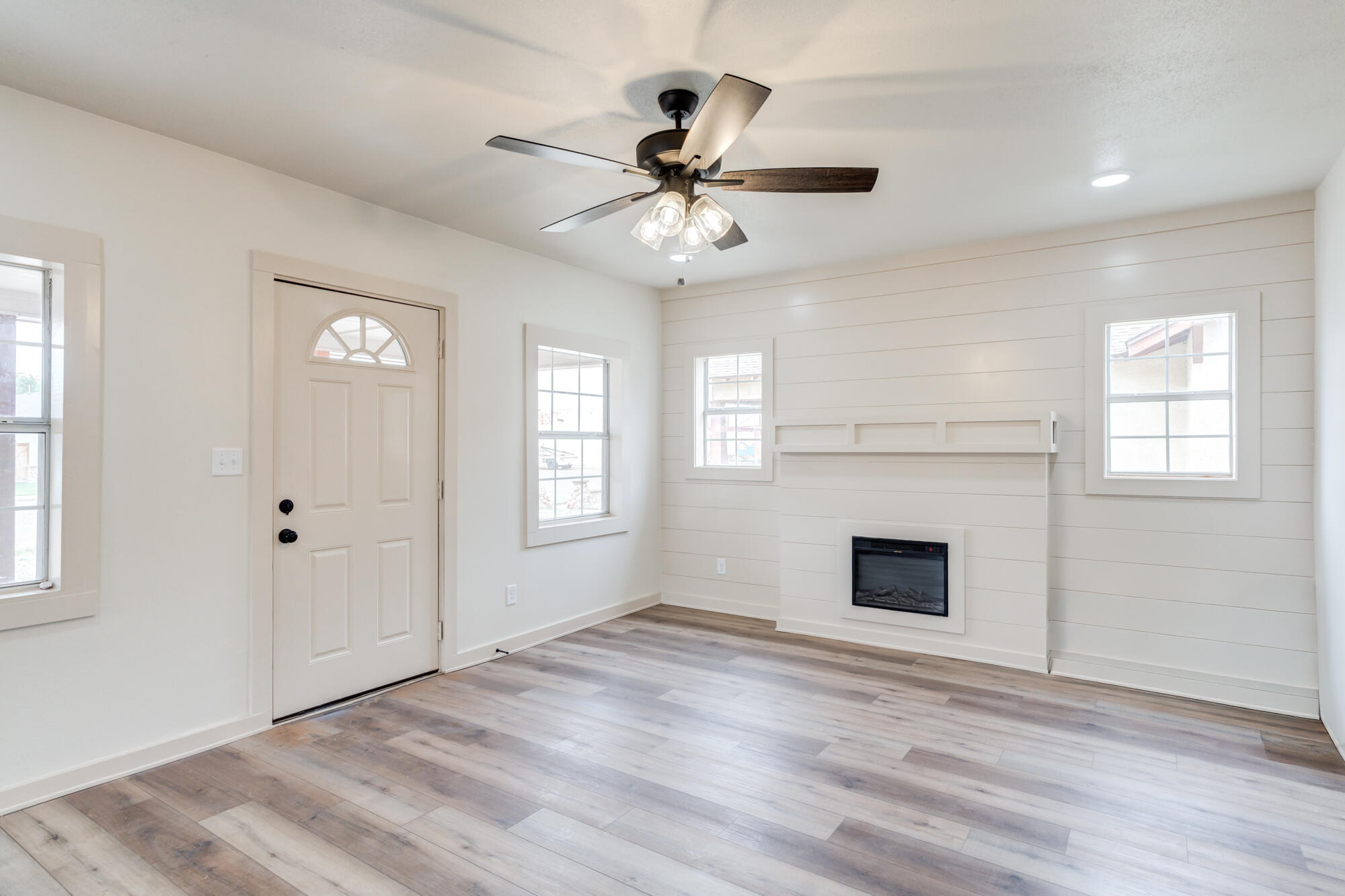 315 West Garza Street Slaton, TX 79364 - Photo 6 of 35 an empty room with windows and fireplace