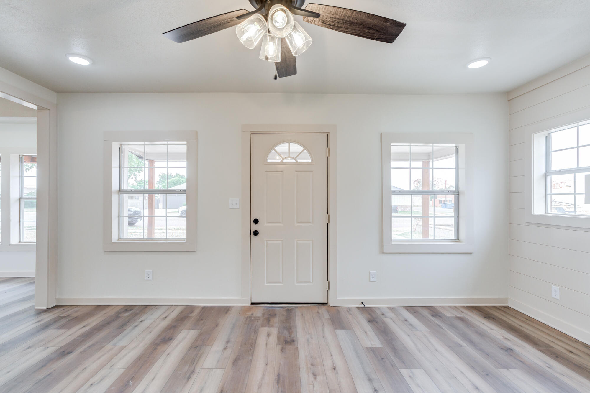 315 West Garza Street Slaton, TX 79364 - Photo 7 of 35 a view of an empty room with a window and wooden floor