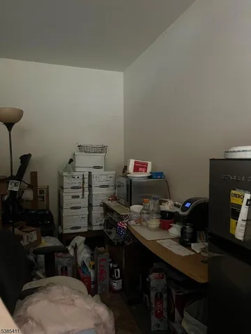 a room with furniture a air conditioner and a window