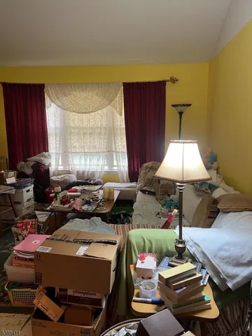 a living room with furniture a window and a lamp