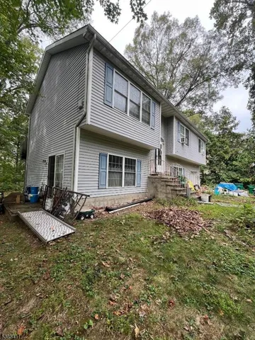 a view of backyard with trees and outdoor seating