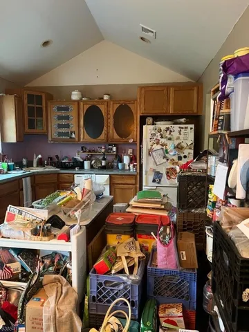 a utility room with lots of clutter and bicycles