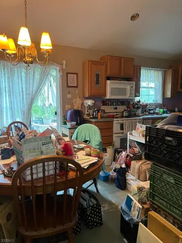 a outdoor kitchen with stainless steel appliances a stove a sink dishwasher and cabinets with wooden floor