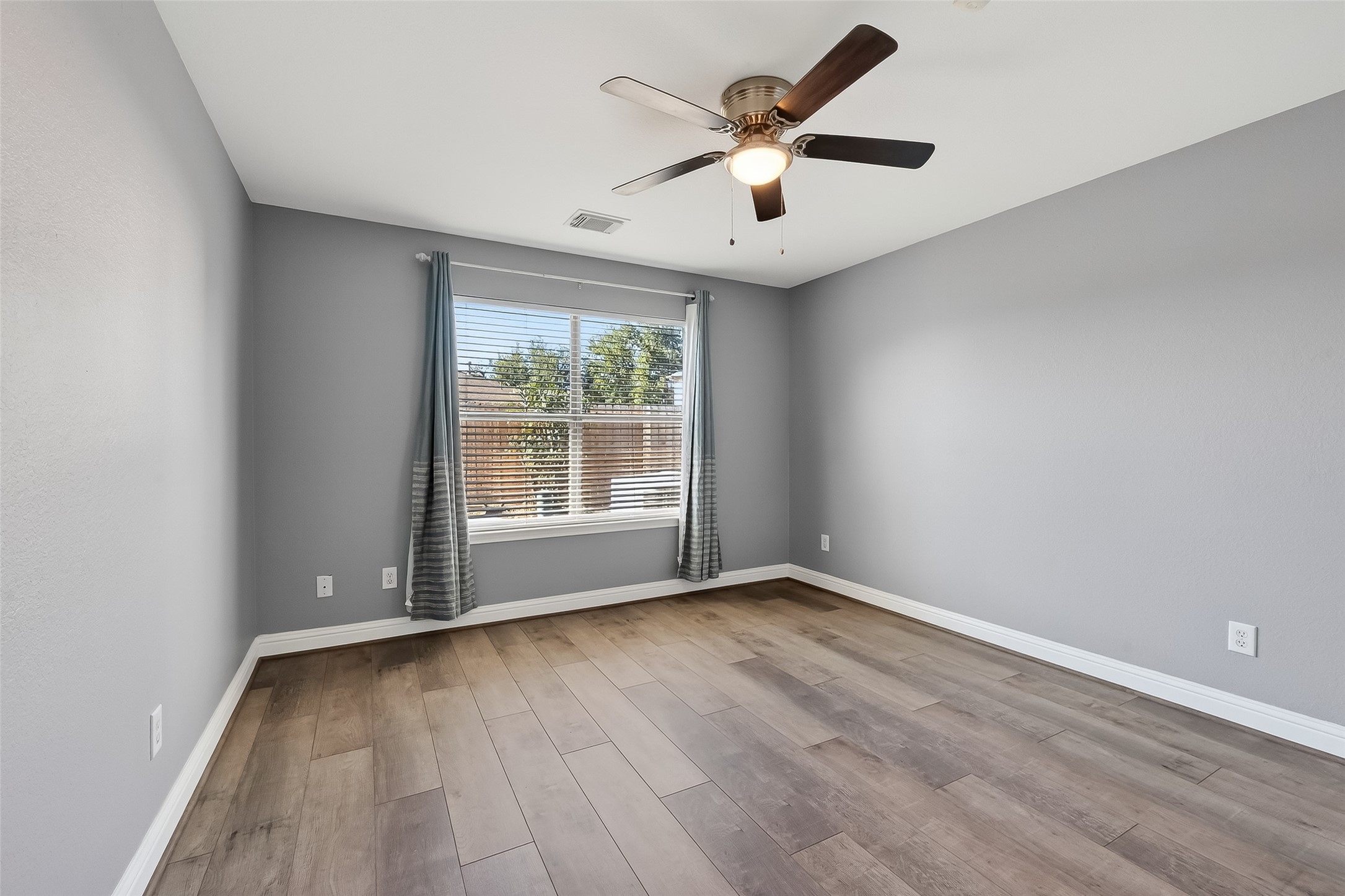 29603 Golden Vines Lane Spring, TX 77386 - Photo 11 of 23 an empty room with wooden floor and windows