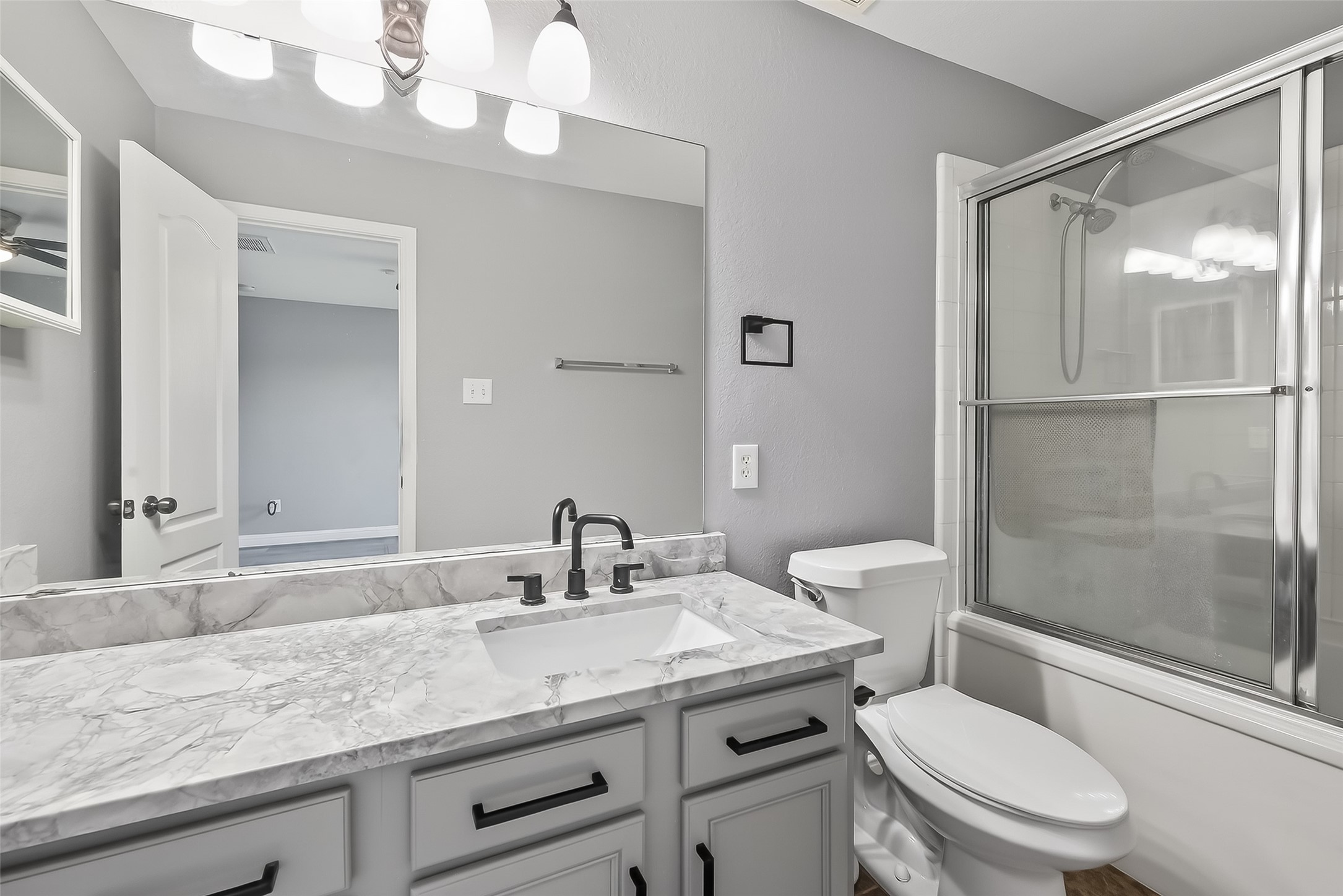29603 Golden Vines Lane Spring, TX 77386 - Photo 13 of 23 a bathroom with a granite countertop sink a toilet a mirror and shower