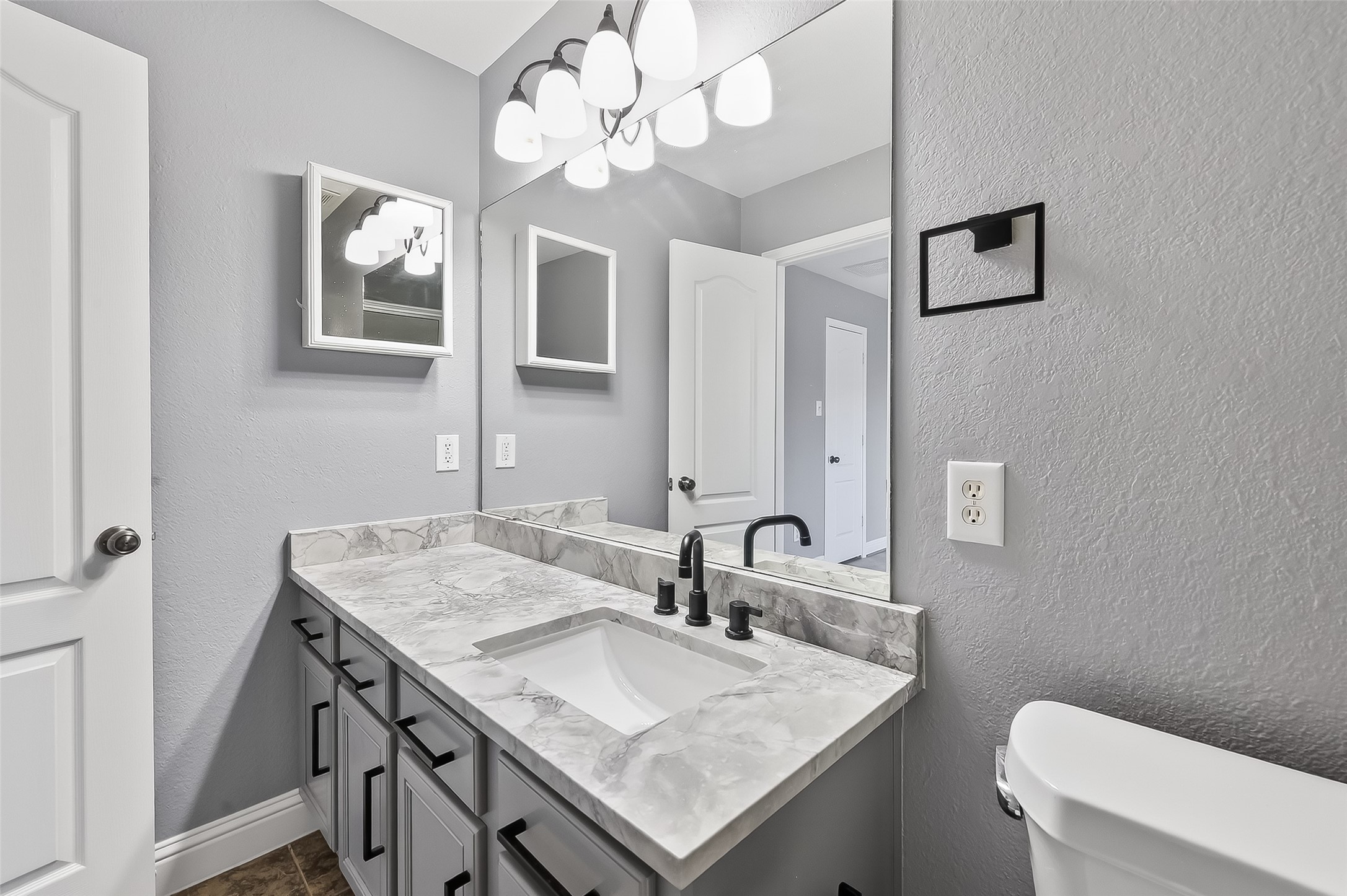 29603 Golden Vines Lane Spring, TX 77386 - Photo 14 of 23 a bathroom with a sink a light fixture and a toilet