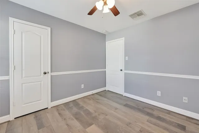 a bathroom with a granite countertop toilet sink and mirror
