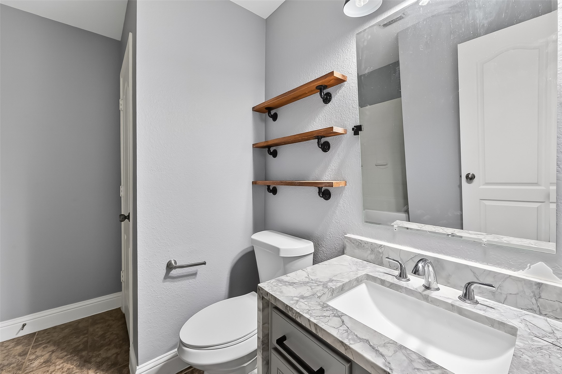 29603 Golden Vines Lane Spring, TX 77386 - Photo 18 of 23 a bathroom with a granite countertop toilet sink and mirror
