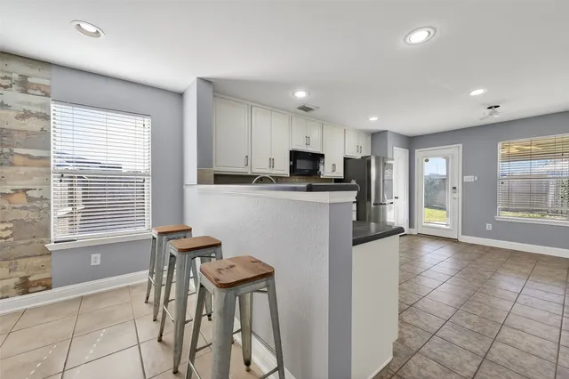 a kitchen with granite countertop cabinets stainless steel appliances and wooden cabinets