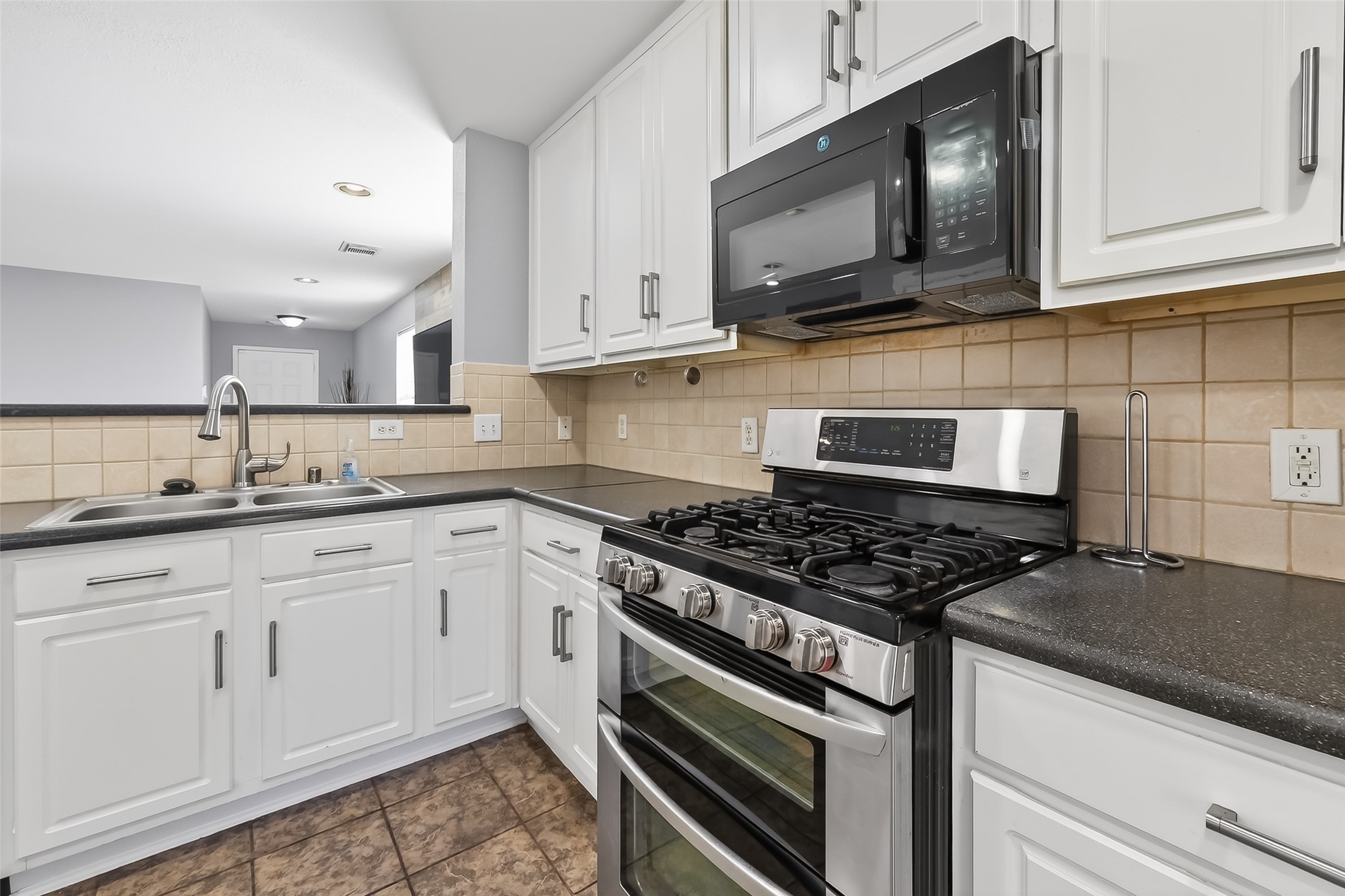 29603 Golden Vines Lane Spring, TX 77386 - Photo 10 of 23 a kitchen with granite countertop cabinets stainless steel appliances and wooden cabinets