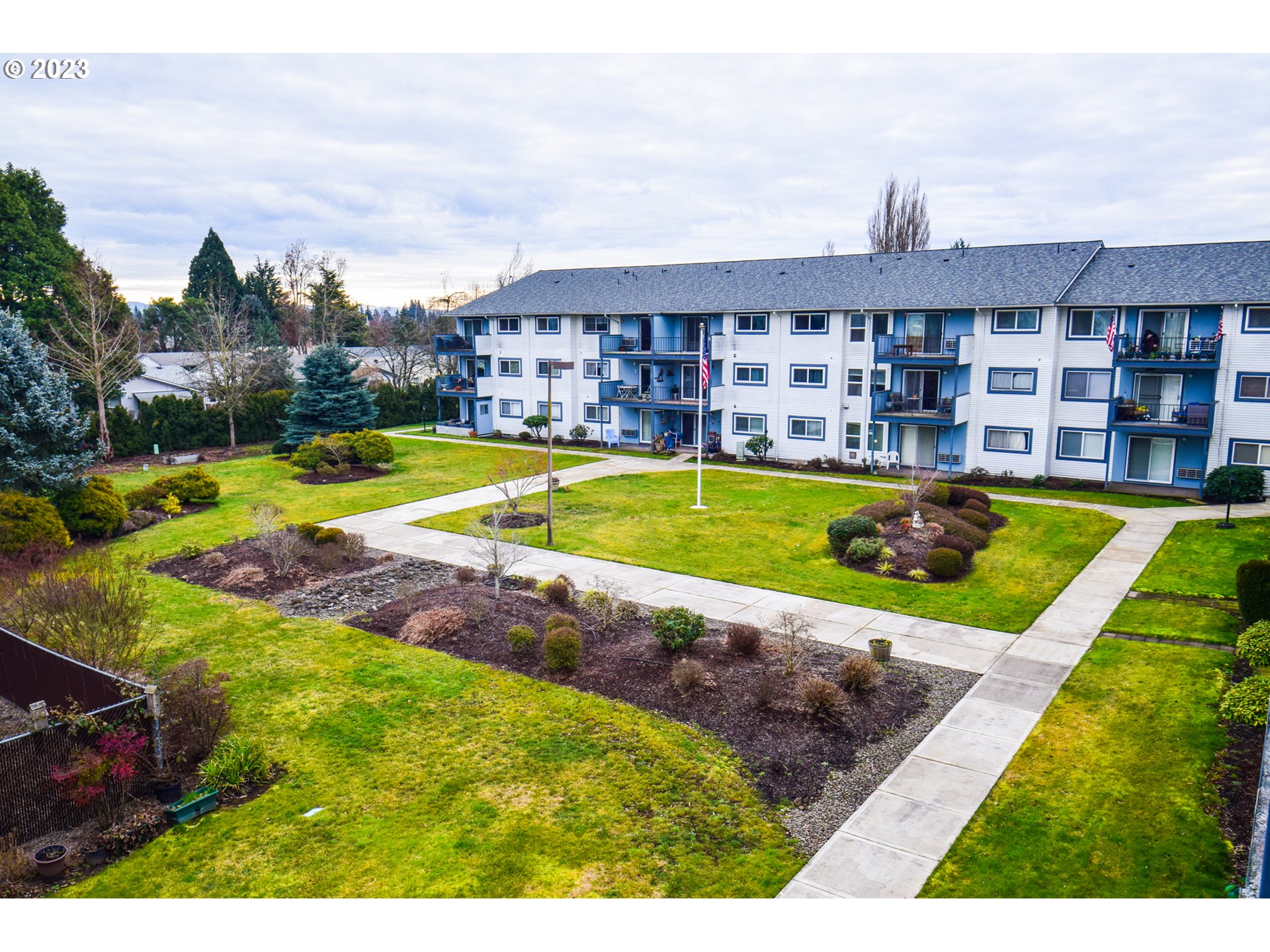 950 Evergreen Road, Unit 312 Woodburn, OR 97071 - Photo 16 of 16 a view of a swimming pool with a yard and plants