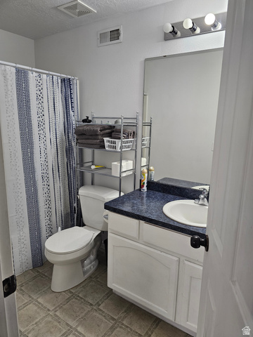 7481 Red Pine Road Eagle Mountain, UT 84005 - Photo 30 of 38 Basement bathroom featuring a white vanity with a blue countertop and integrated sink, a large wall-mounted mirror, and overhead strip lighting
