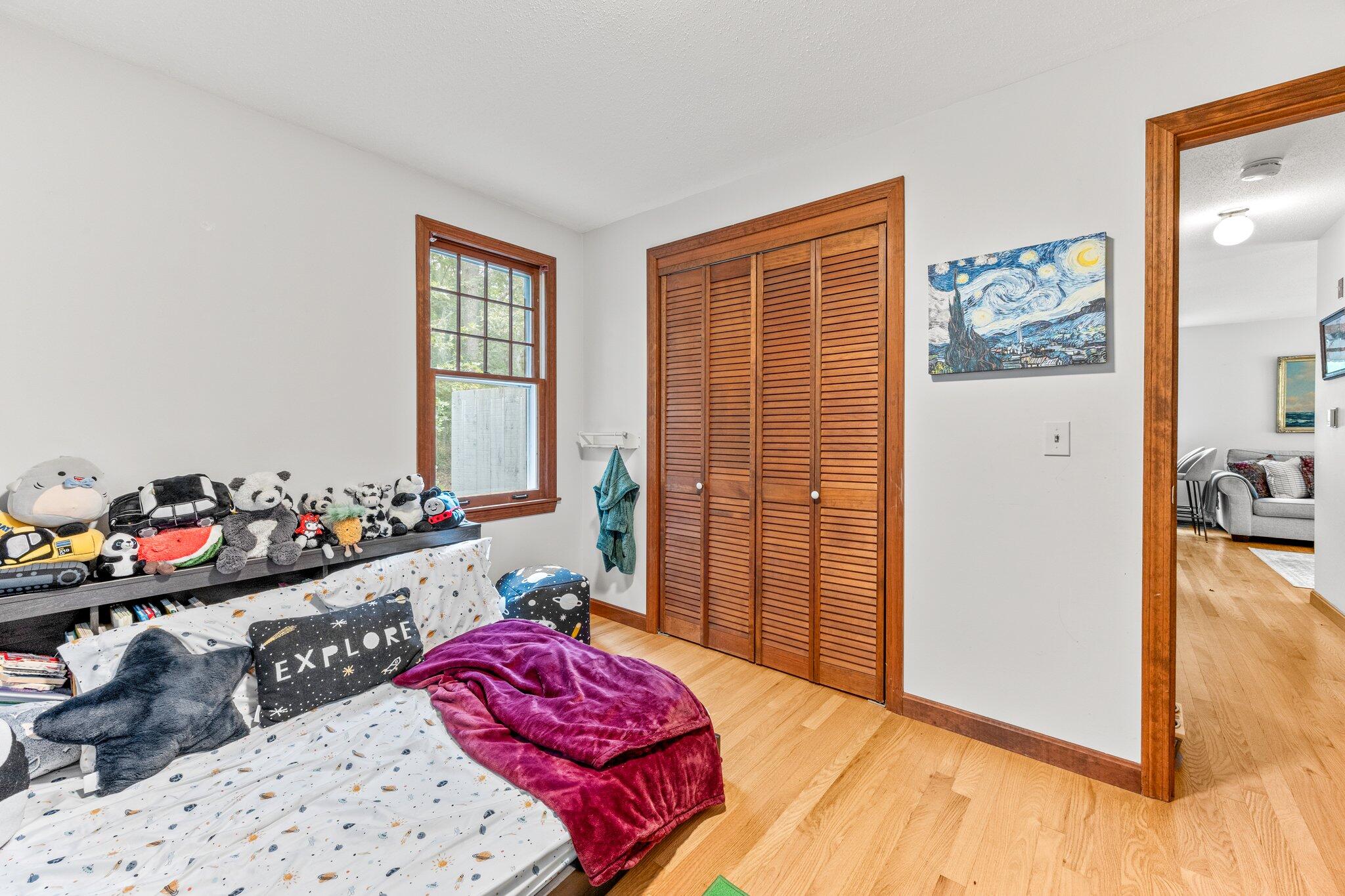 243 Commons Way Brewster, MA 02631 - Photo 16 of 32 a bedroom with furniture and a large window