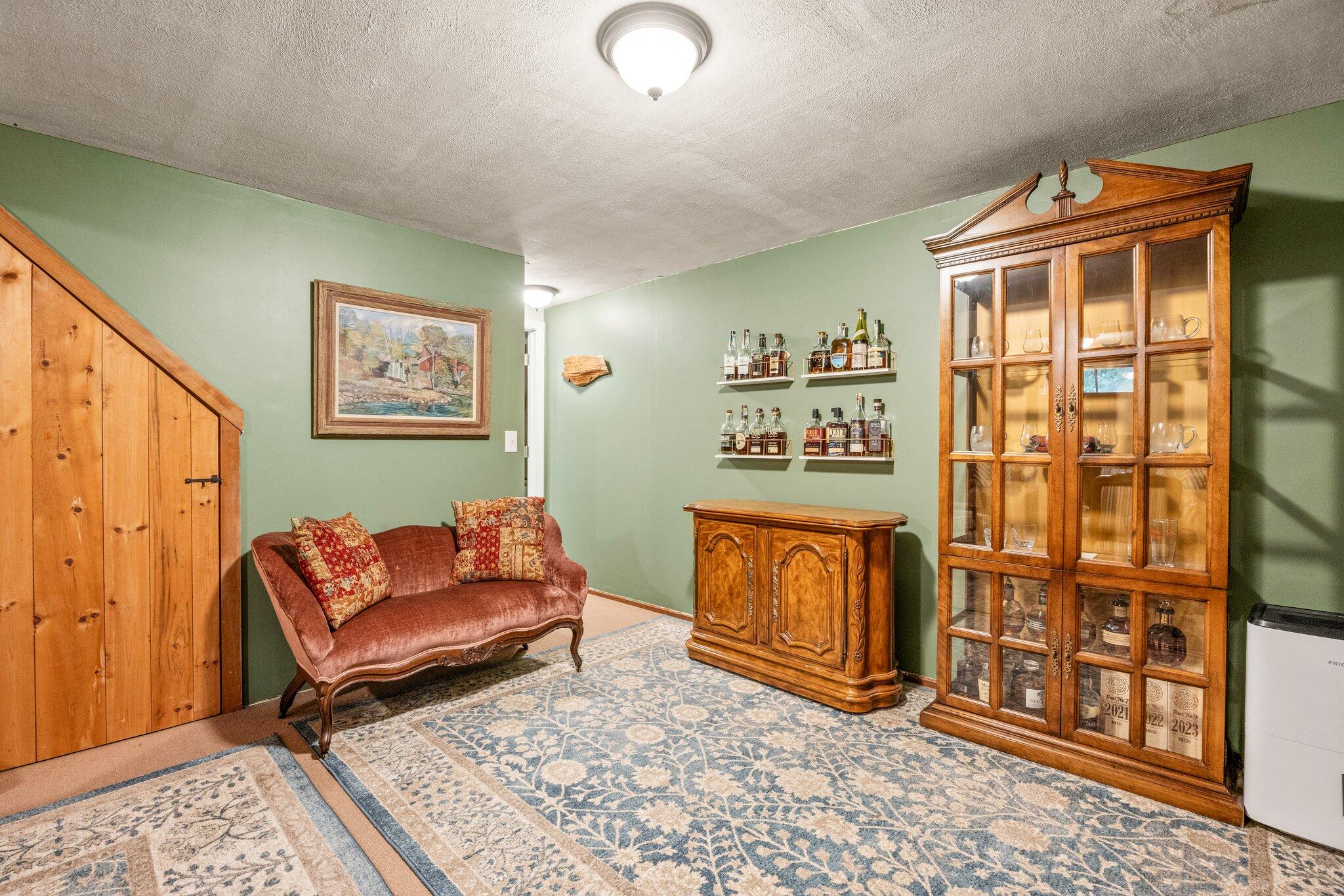 243 Commons Way Brewster, MA 02631 - Photo 17 of 32 a living room with stainless steel furniture and paintings on the wall