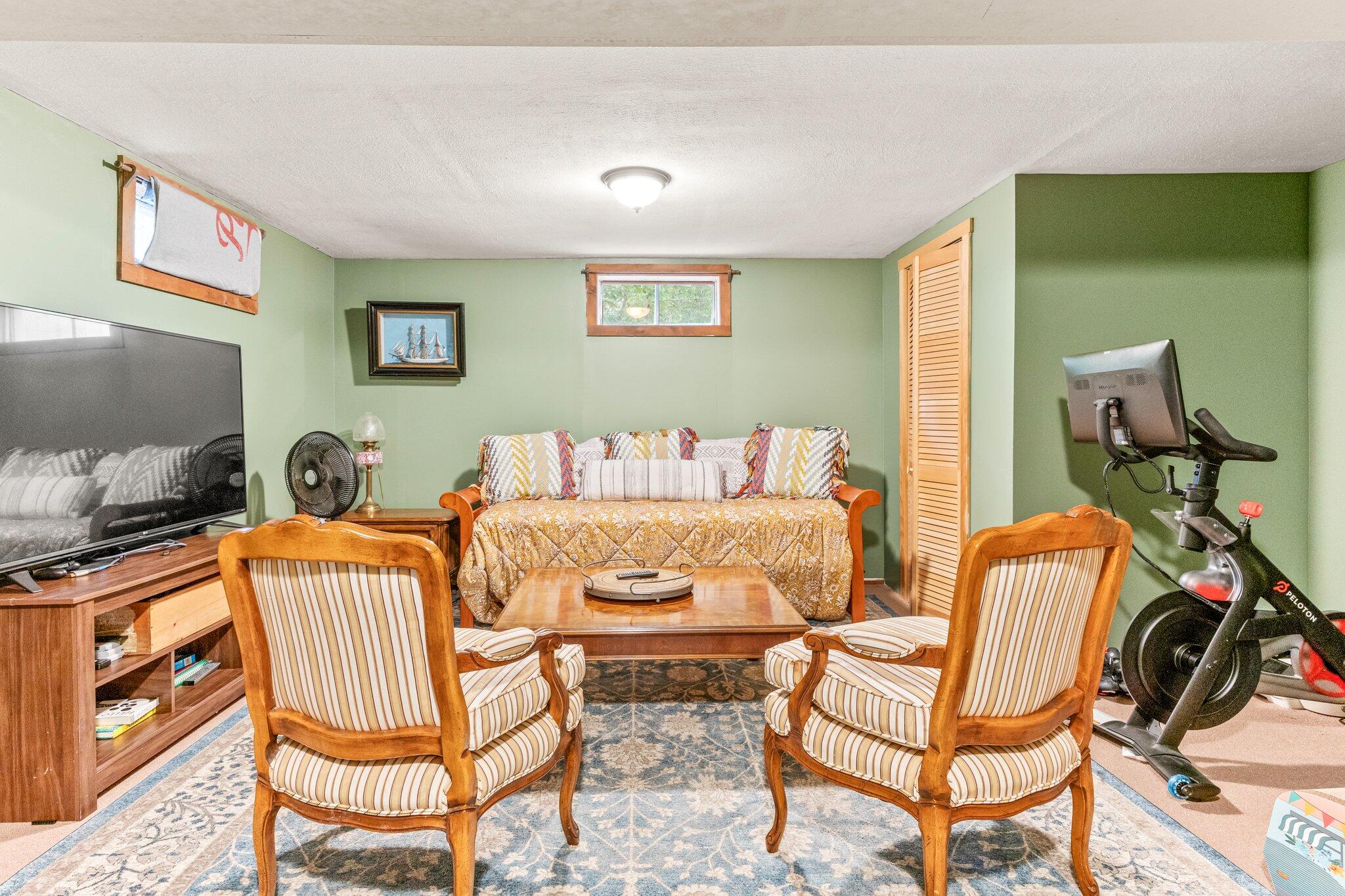 243 Commons Way Brewster, MA 02631 - Photo 18 of 32 a living room with a couch and a flat screen tv