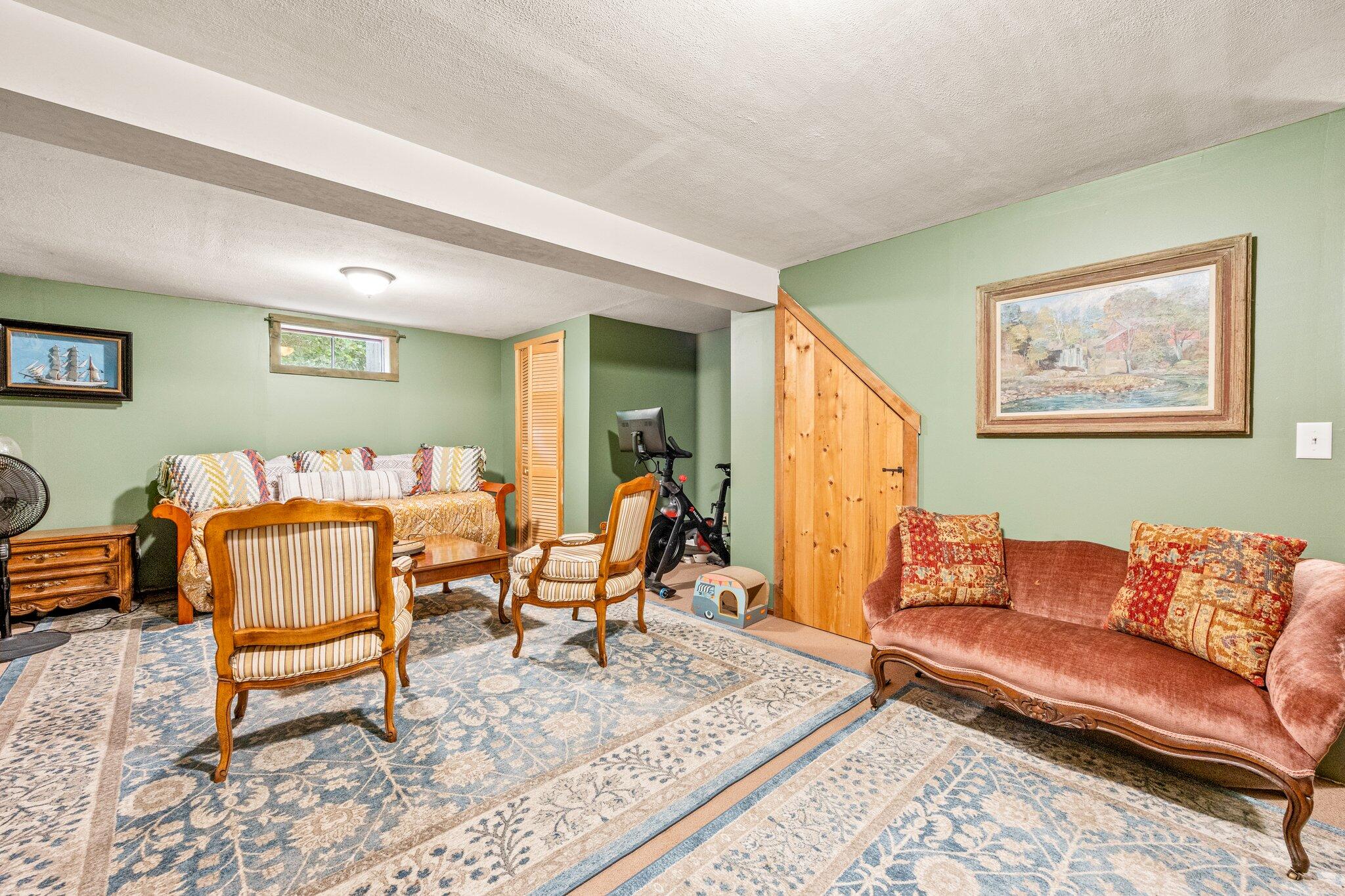 243 Commons Way Brewster, MA 02631 - Photo 19 of 32 a living room with furniture and a rug