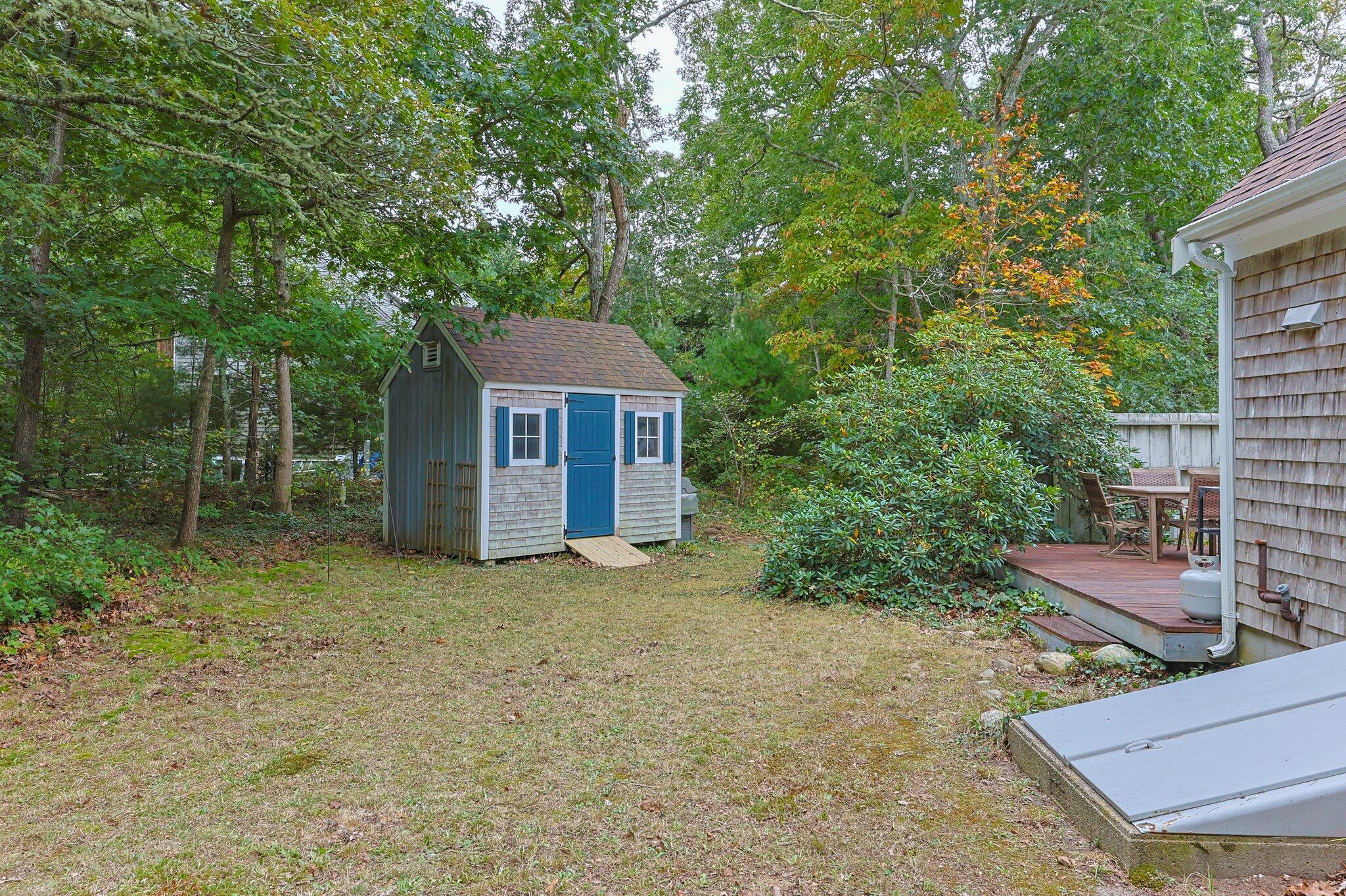 243 Commons Way Brewster, MA 02631 - Photo 27 of 32 a house with trees in front of it