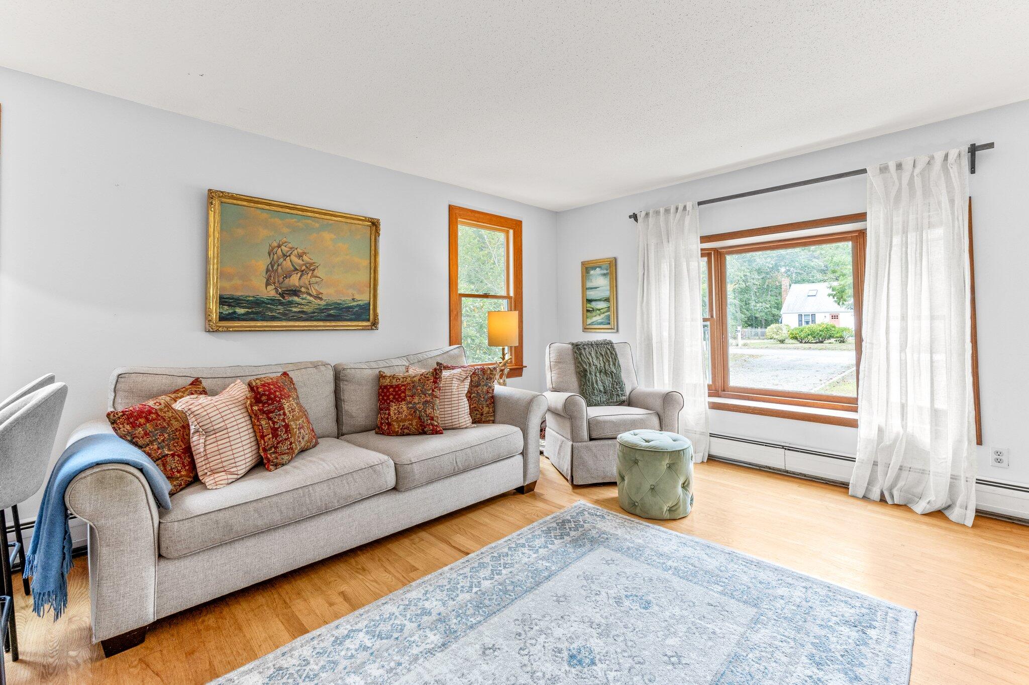 243 Commons Way Brewster, MA 02631 - Photo 4 of 32 a living room with furniture and a large window