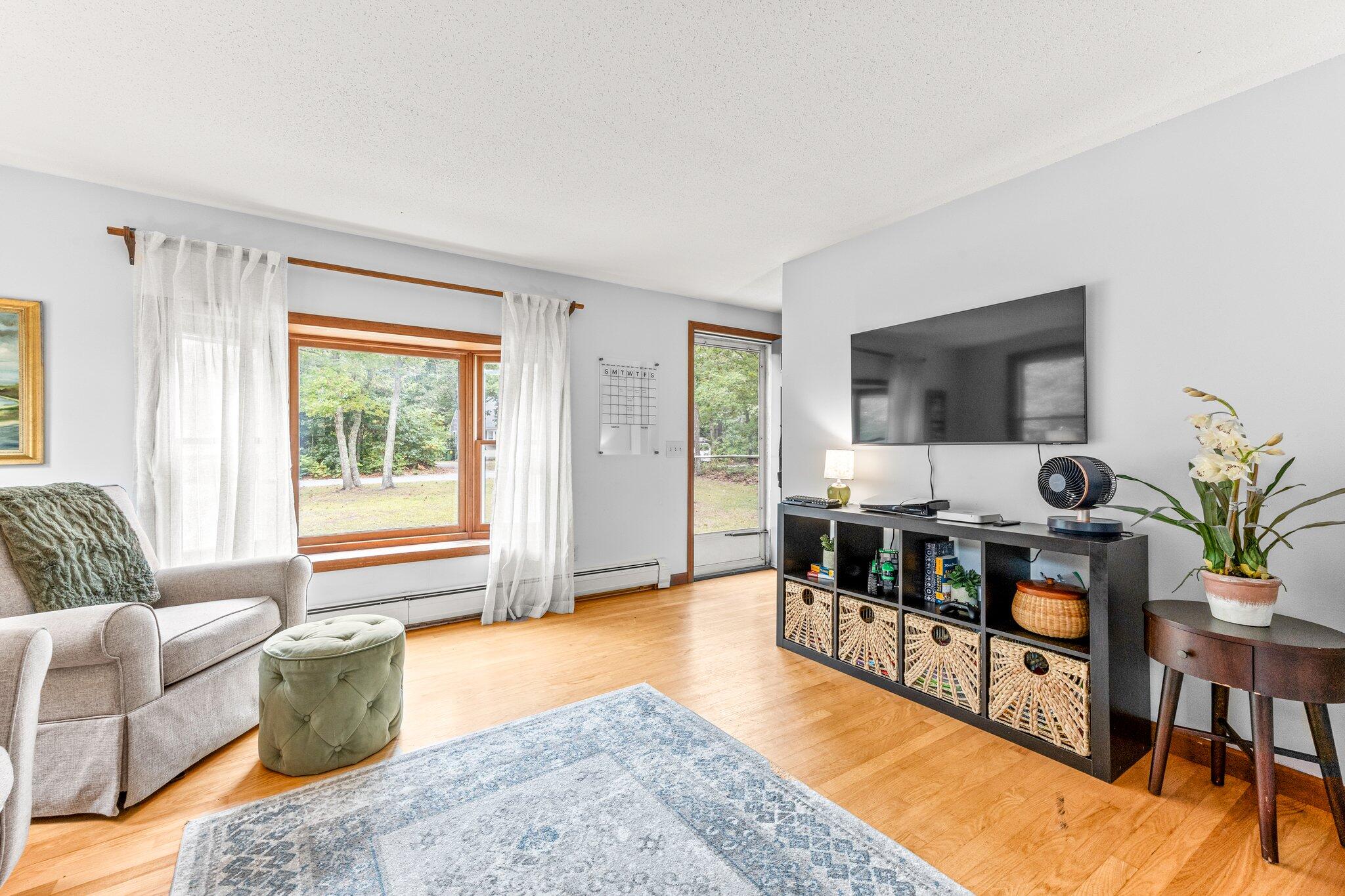 243 Commons Way Brewster, MA 02631 - Photo 6 of 32 a living room with furniture and a table