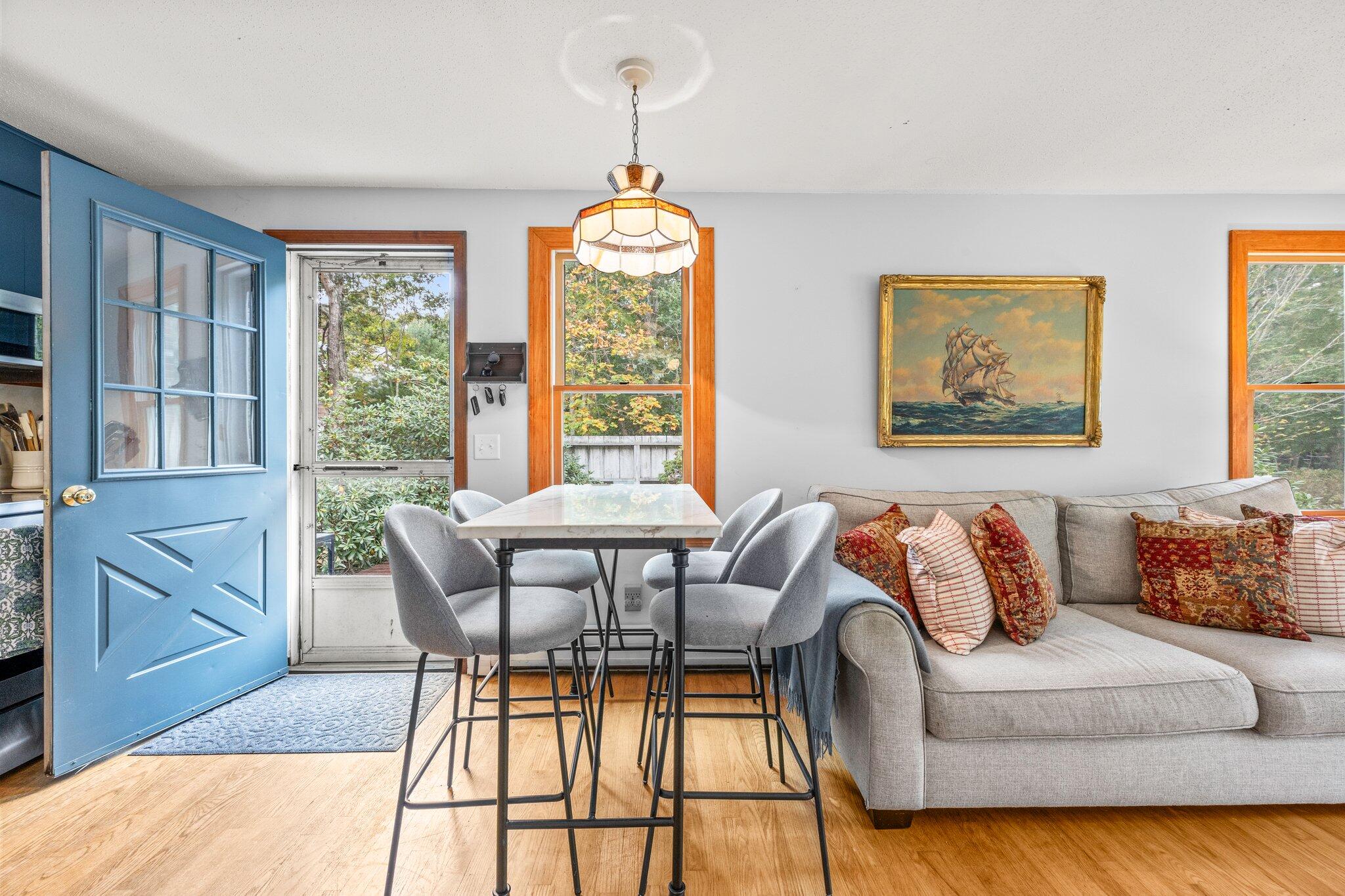 243 Commons Way Brewster, MA 02631 - Photo 7 of 32 a view of a dining room with furniture wooden floor and a chandelier