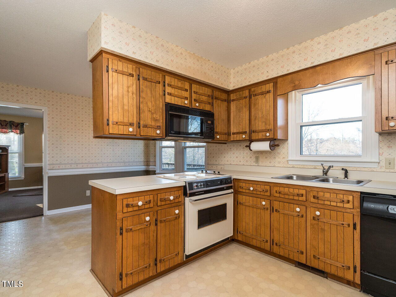 402 Hillside Drive Smithfield, NC 27577 - Photo 11 of 27 a kitchen with a stove a sink and a microwave