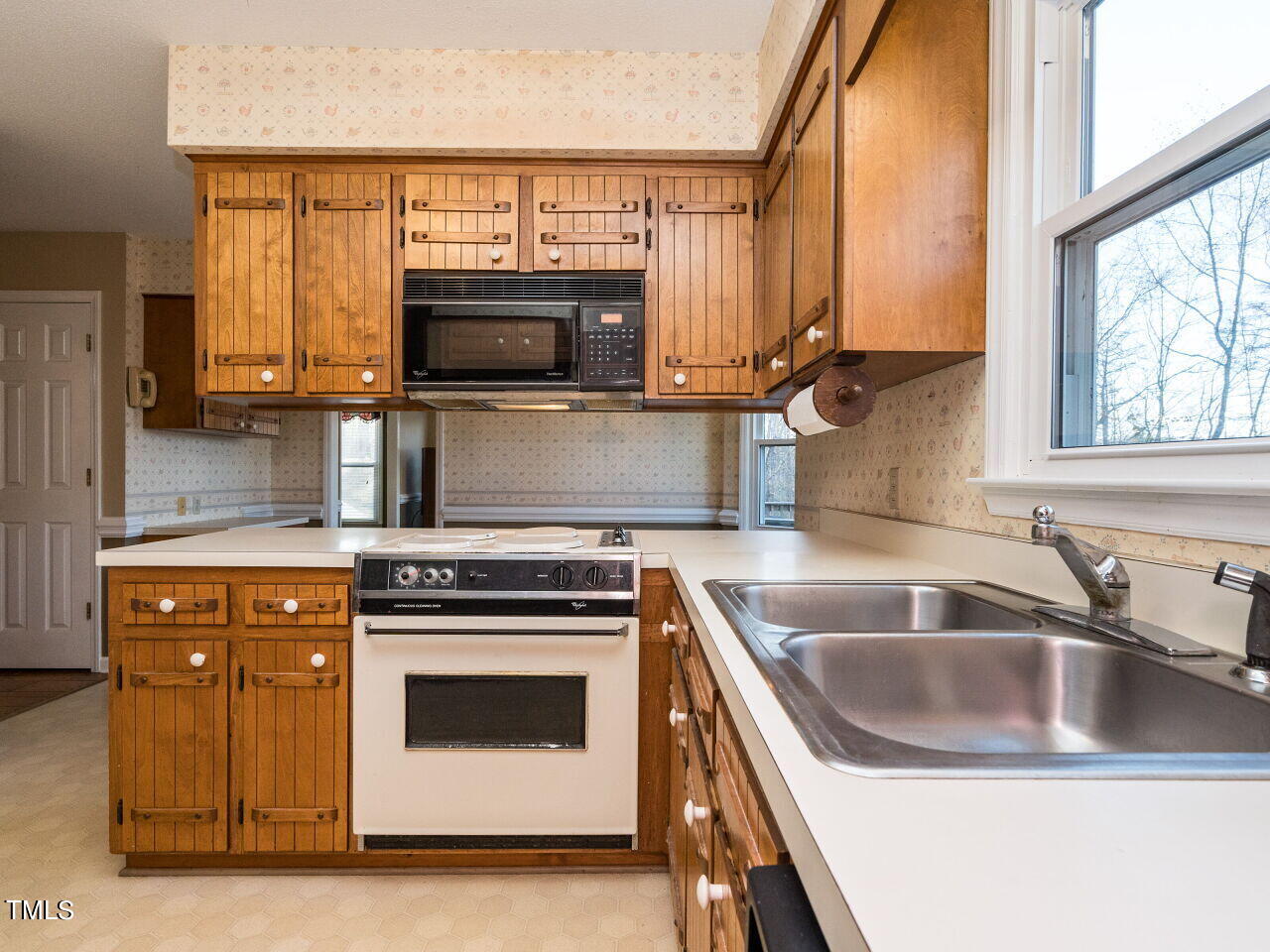 402 Hillside Drive Smithfield, NC 27577 - Photo 12 of 27 a kitchen with granite countertop a sink a stove and microwave