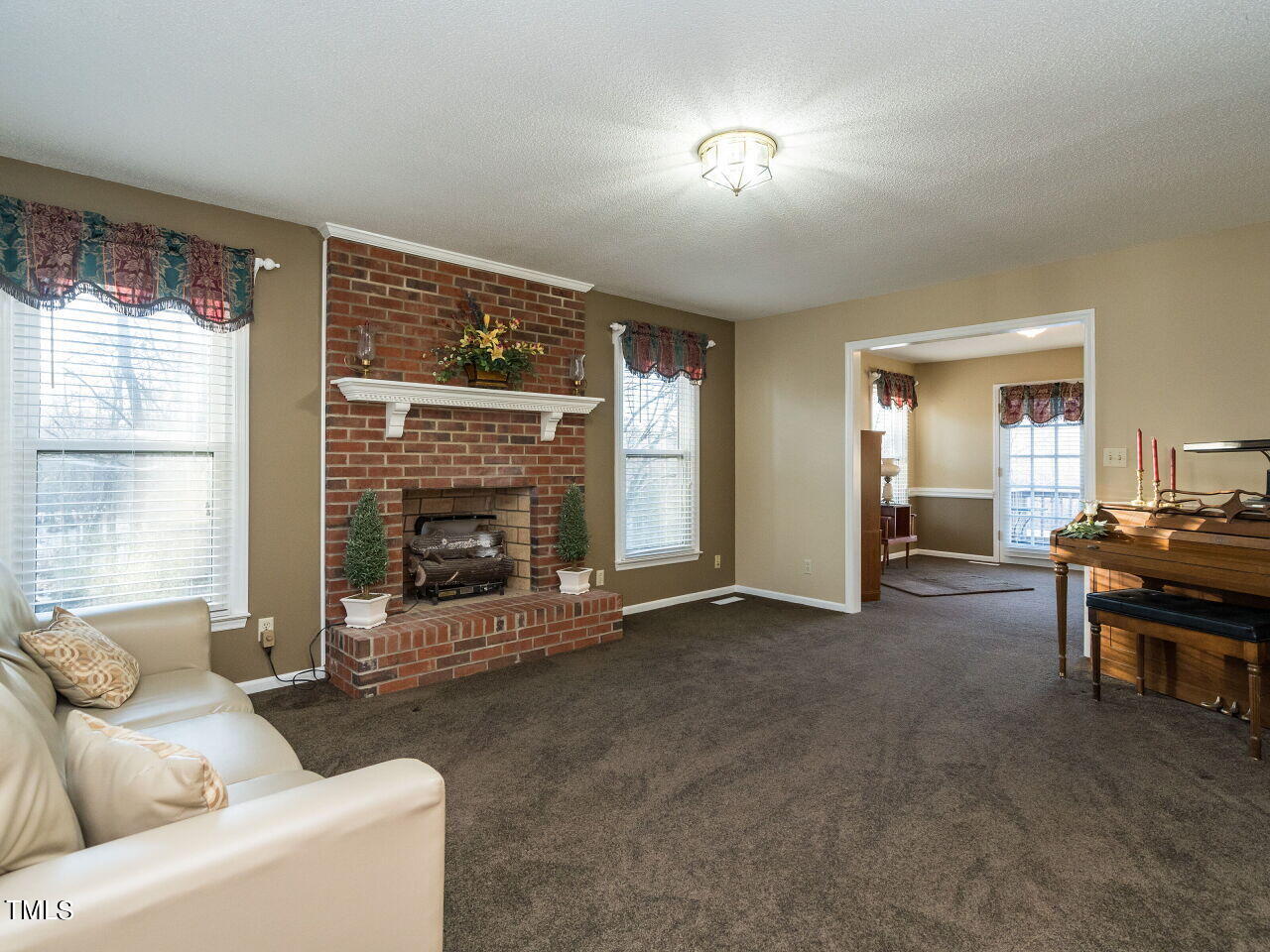 402 Hillside Drive Smithfield, NC 27577 - Photo 5 of 27 a living room with furniture and a fireplace