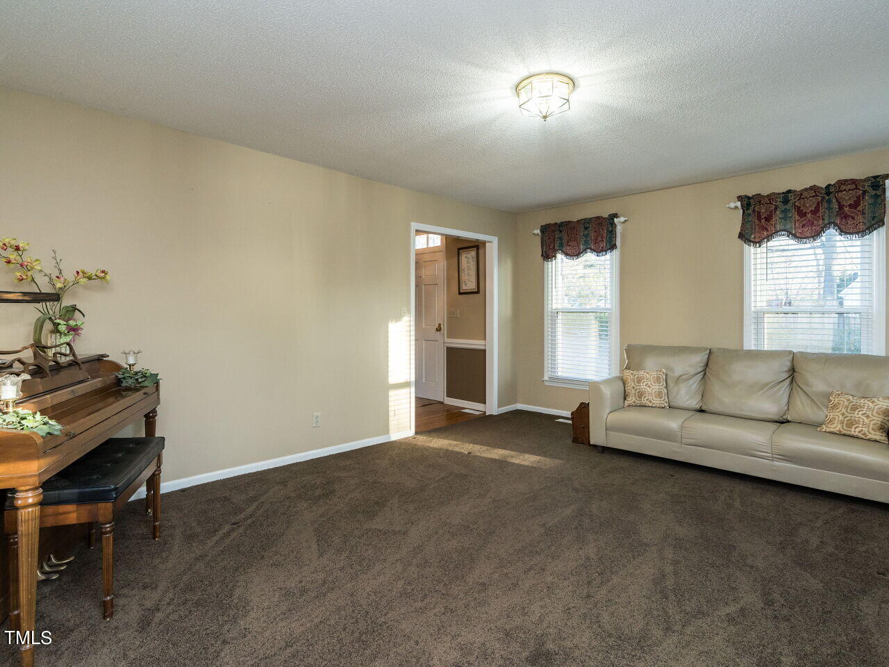 402 Hillside Drive Smithfield, NC 27577 - Photo 6 of 27 a living room with furniture and a window