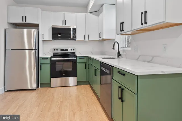 a kitchen with stainless steel appliances a stove sink and refrigerator