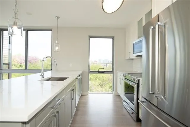 a kitchen with a sink a stove and a microwave