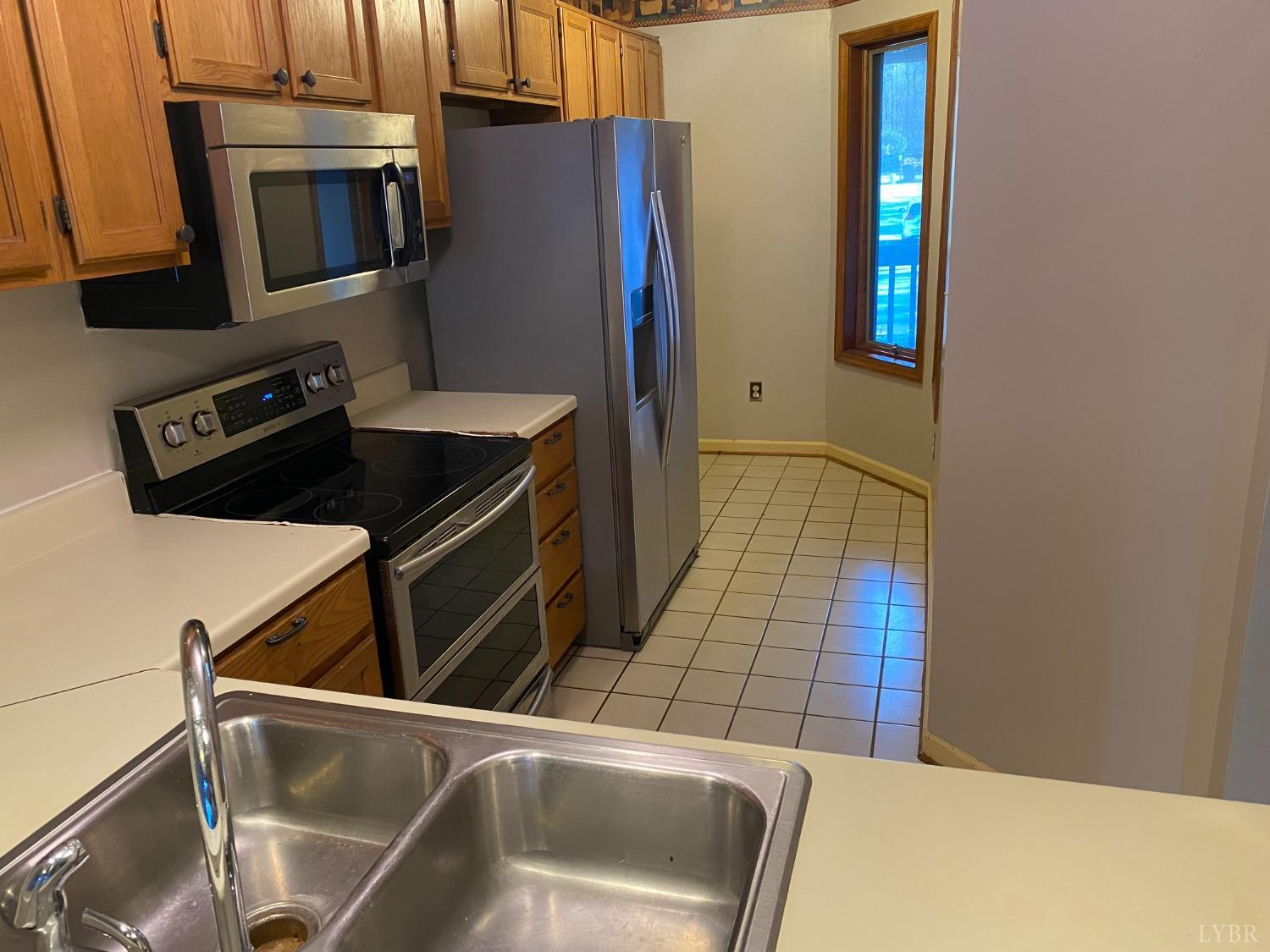 107 Manor Drive Forest, VA 24551 - Photo 4 of 20 a kitchen with a refrigerator and a sink