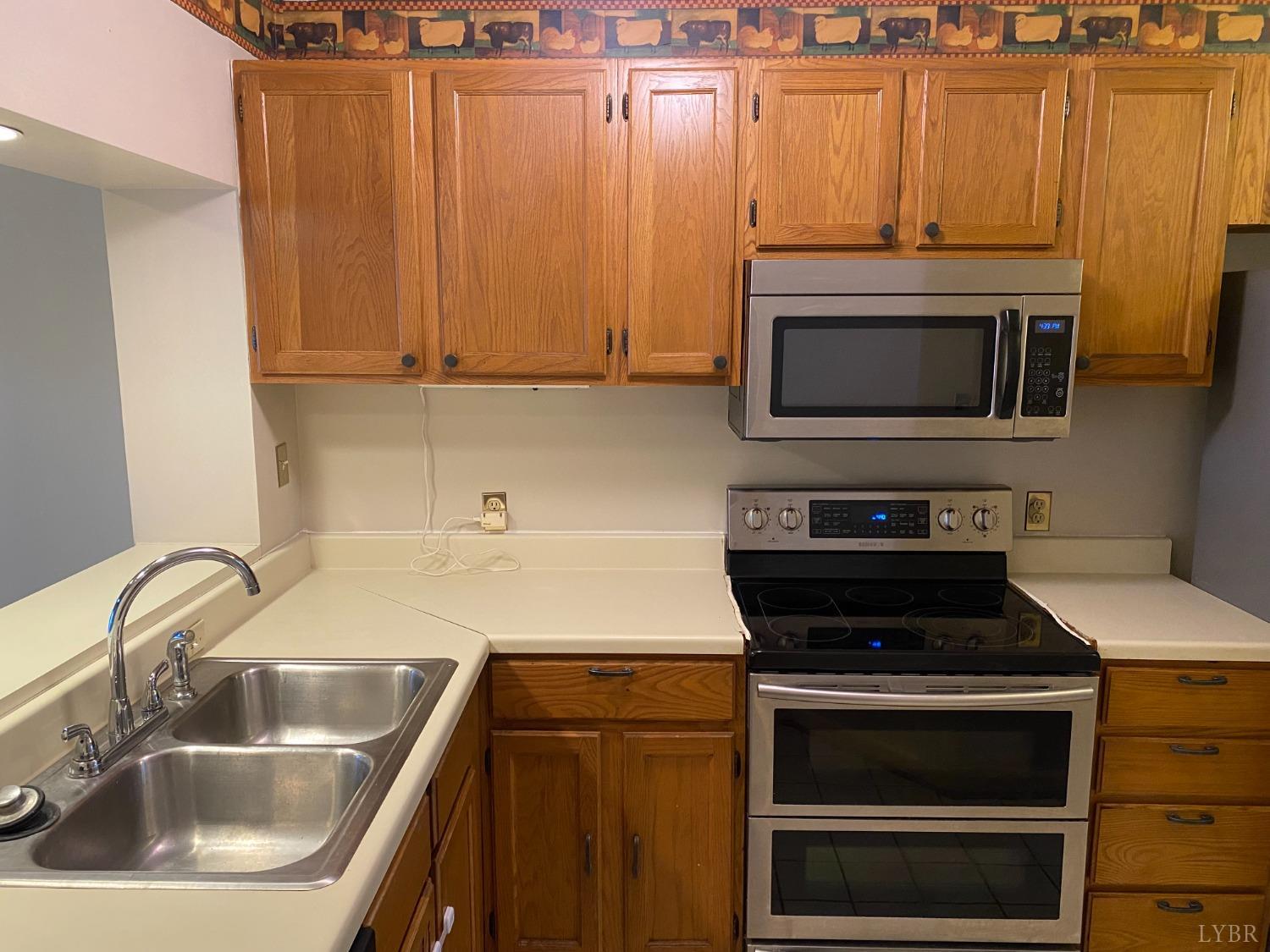 107 Manor Drive Forest, VA 24551 - Photo 5 of 20 a kitchen with a sink stove and microwave