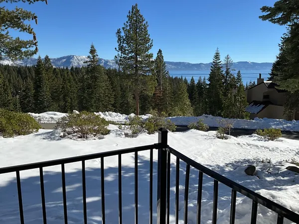 a view of a wooden deck next to a house