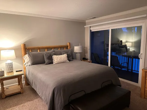 a large bed sitting in a bedroom and lamp
