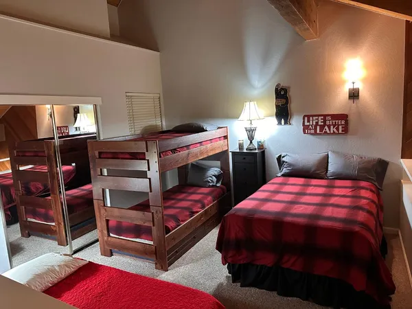 a bedroom with two beds and a lamp