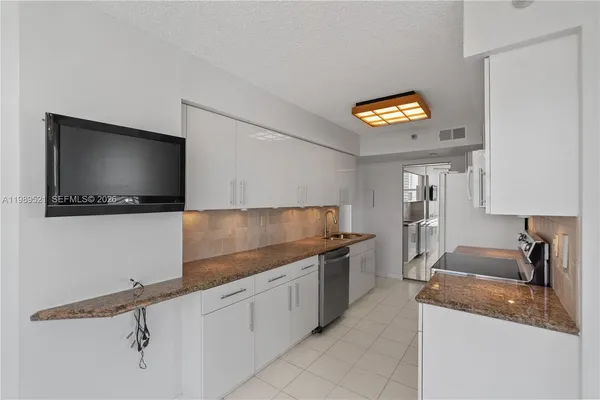 a kitchen with stainless steel appliances granite countertop a sink stove and cabinets