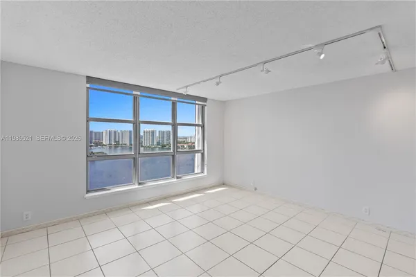 a view of an empty room and closet area