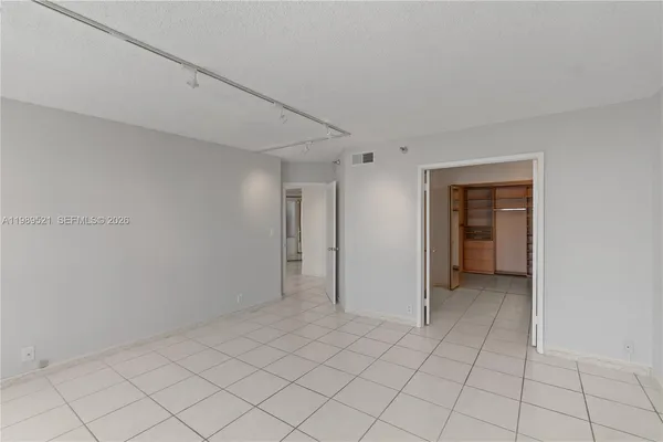 a spacious bathroom with a granite countertop sink a mirror and a shower