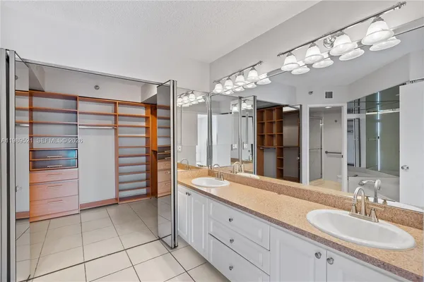 a bathroom with a tub a sink and shower
