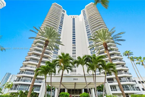 a body of water with a tree in the background