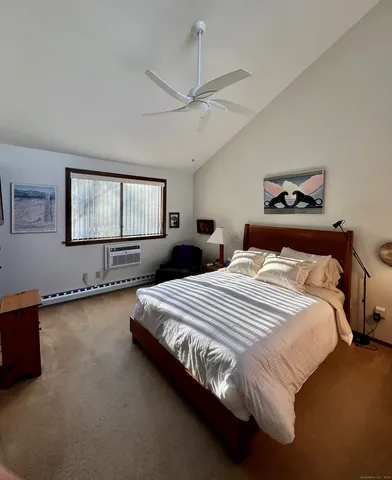 a bedroom with a bed and a chair