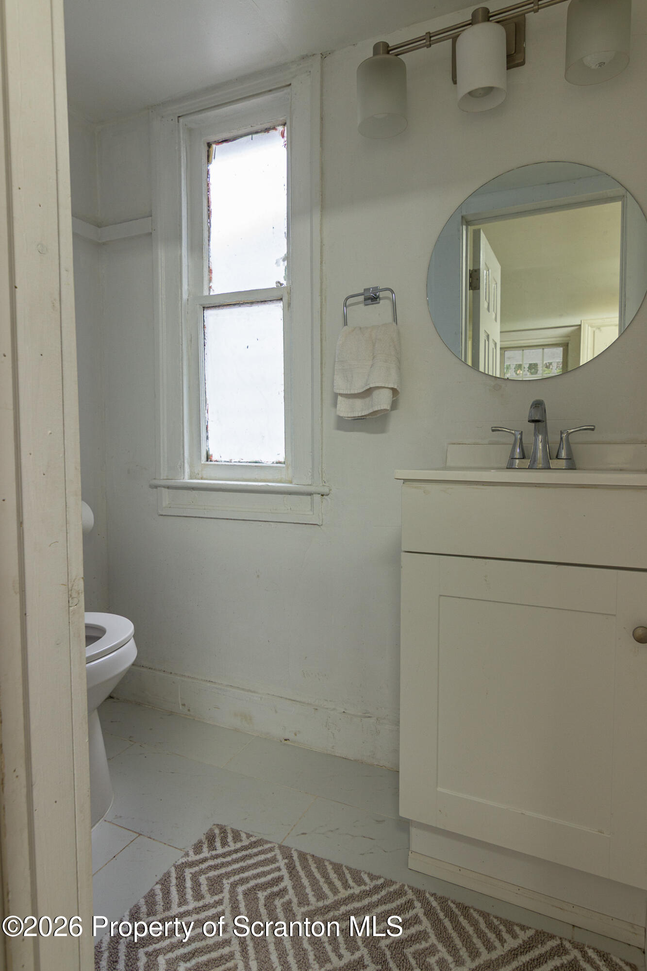 214 William Street Scranton, PA 18508 - Photo 27 of 33 a bathroom with a toilet sink and mirror