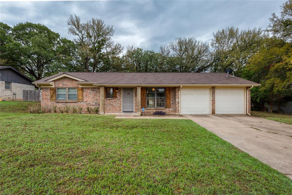 708 North Stewart Street Azle, TX 76020 - Photo 1 of 1 a front view of a house with a garden