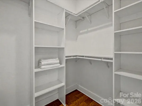 a view of walk in closet with empty racks