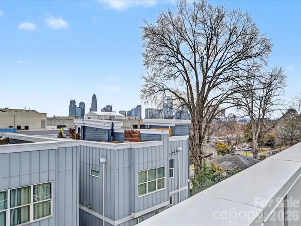 a view of a roof deck with tall trees